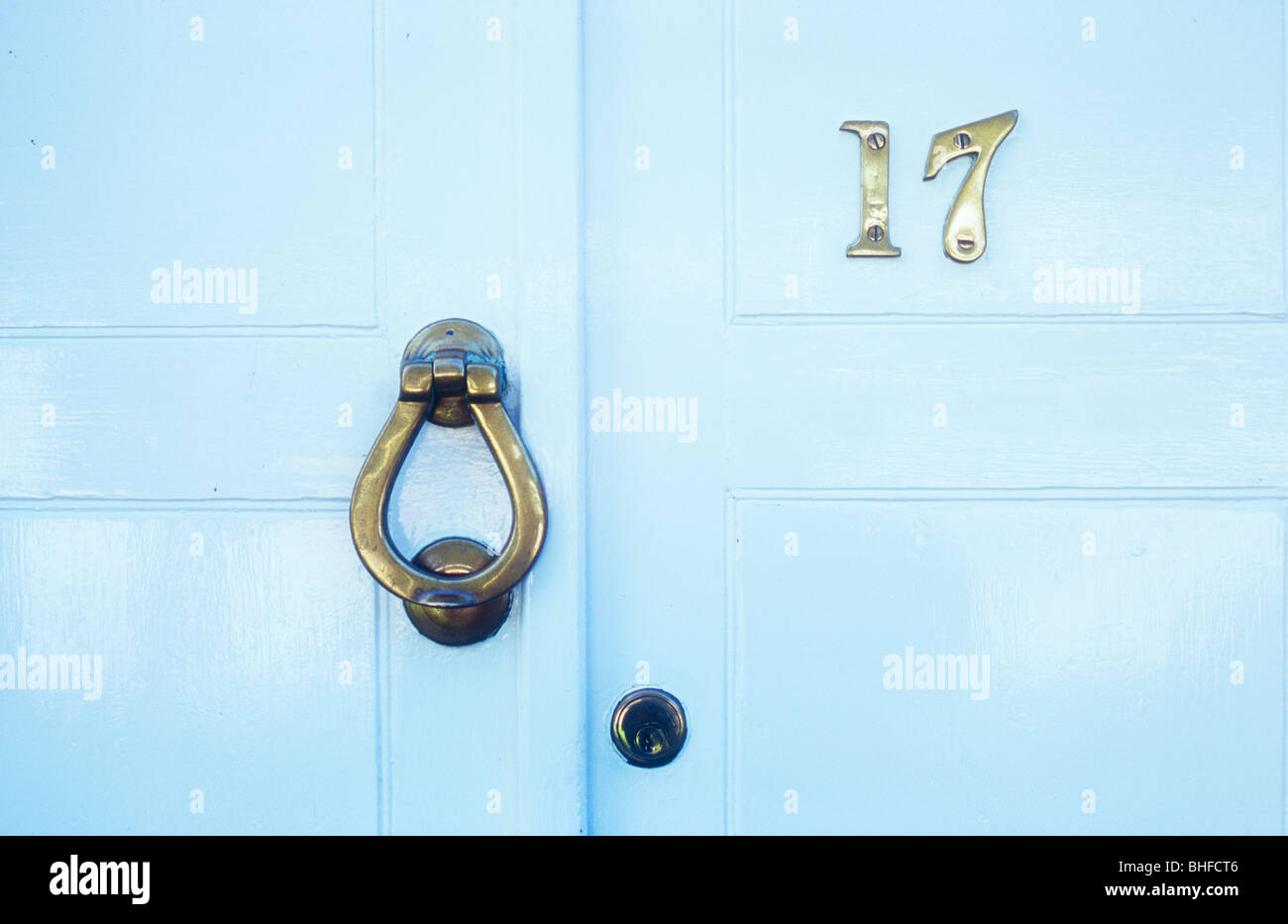Detail of stylish white painted Georgian front door with brass number 17 and knocker Stock Photo
