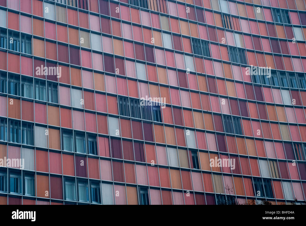 red glass windows in former Eastern Berlin near Checkpoint Charlie Germany Europe Stock Photo