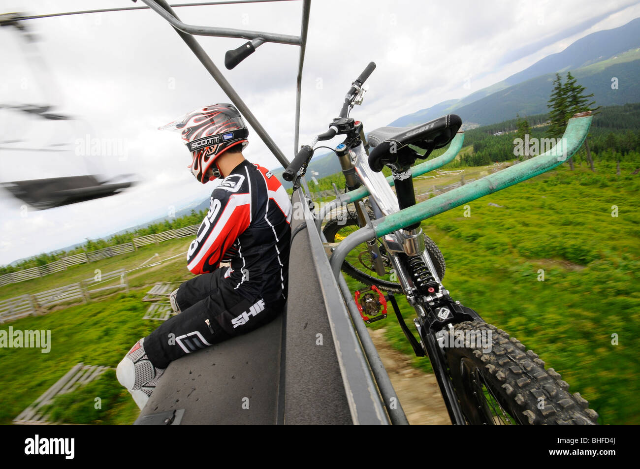 Man with helmet and mountain bike on a chair lift, Mount Plan, Bohemian