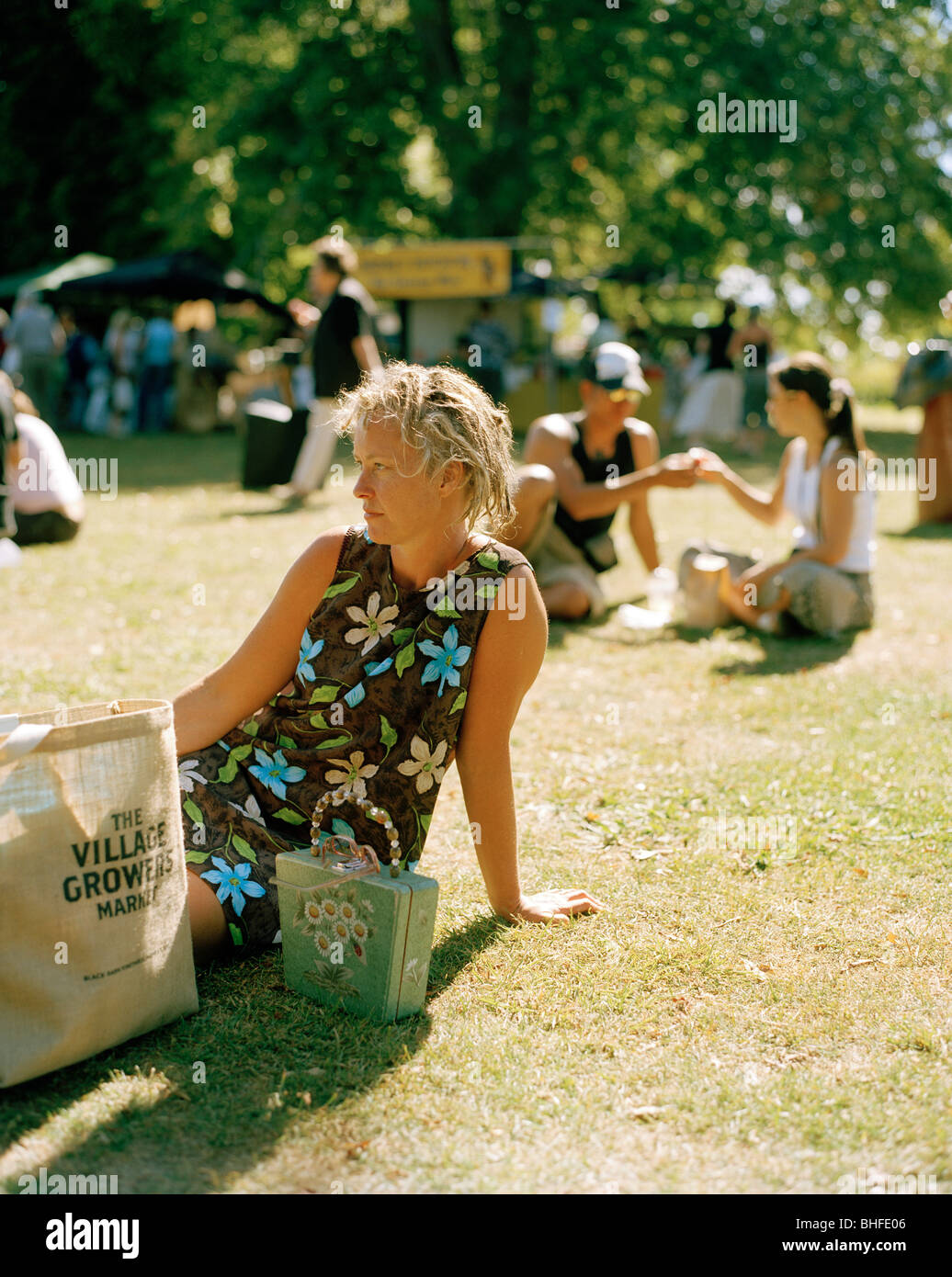 People having a picnic on a meadow in the sunlight, Farmers Market, Hastings, Hawke`s Bay, North Island, New Zealand Stock Photo