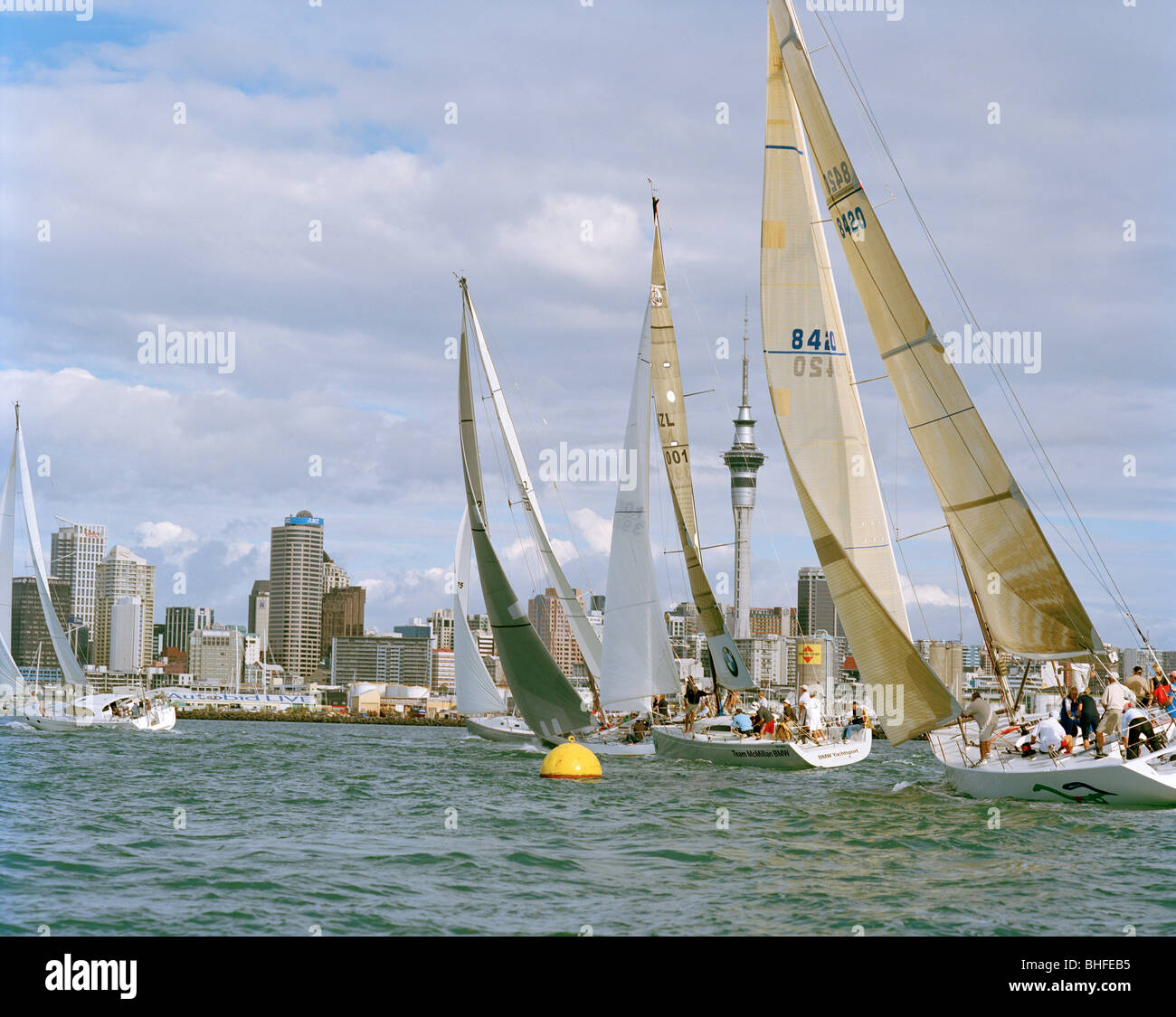 Sail Rise Sailing boats at full speed in front of the high rise buildings at ...