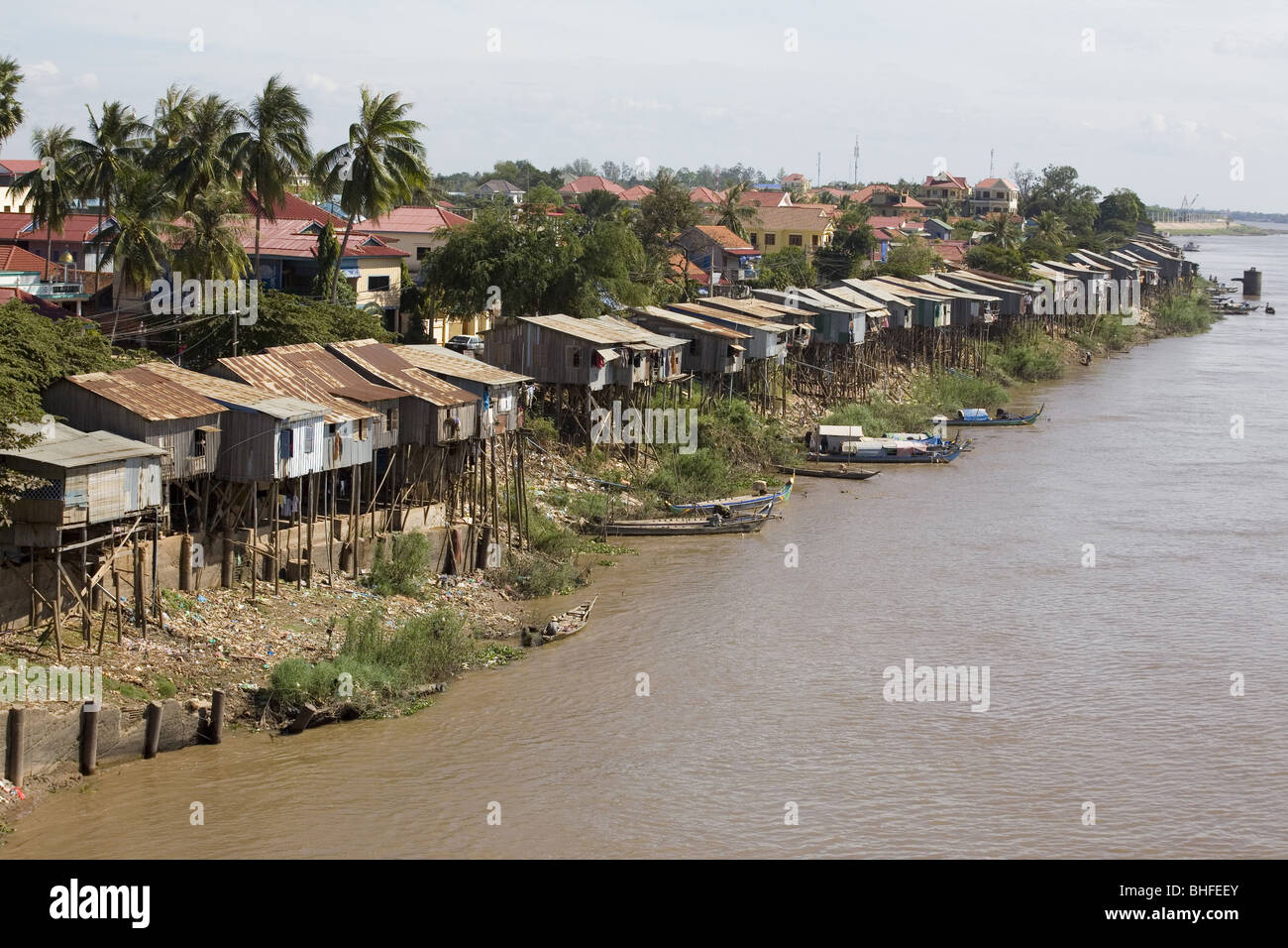 Huts built on stilts at the river Tonle Sap under clouded sky, Phnom Penh, Cambodia, Asia Stock Photo