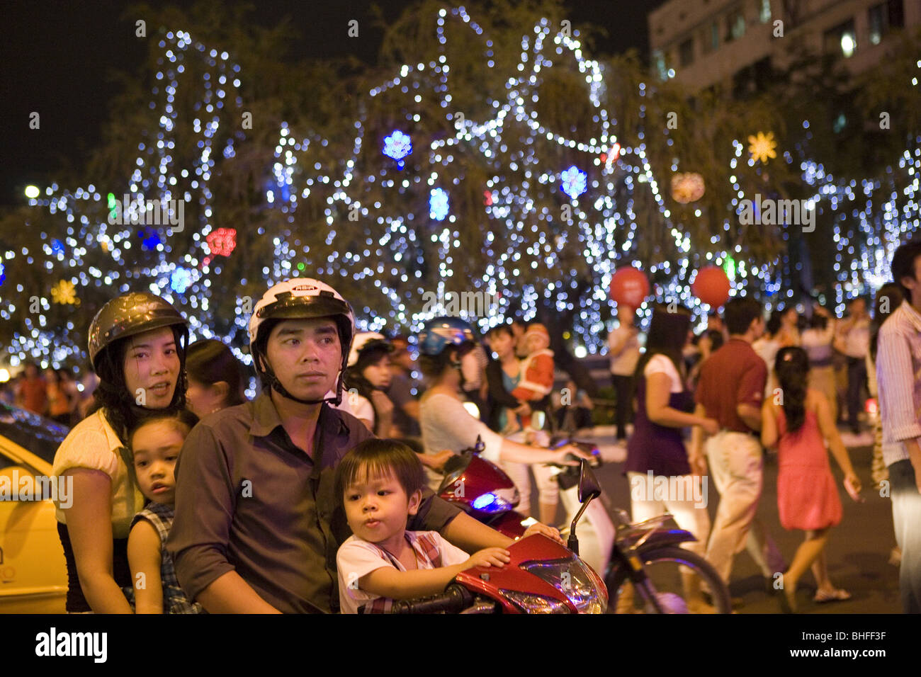 Young vietnamese family in front of christmas decoration downtown Saigon, Hoh Chi Minh City, Vietnam, Asia Stock Photo