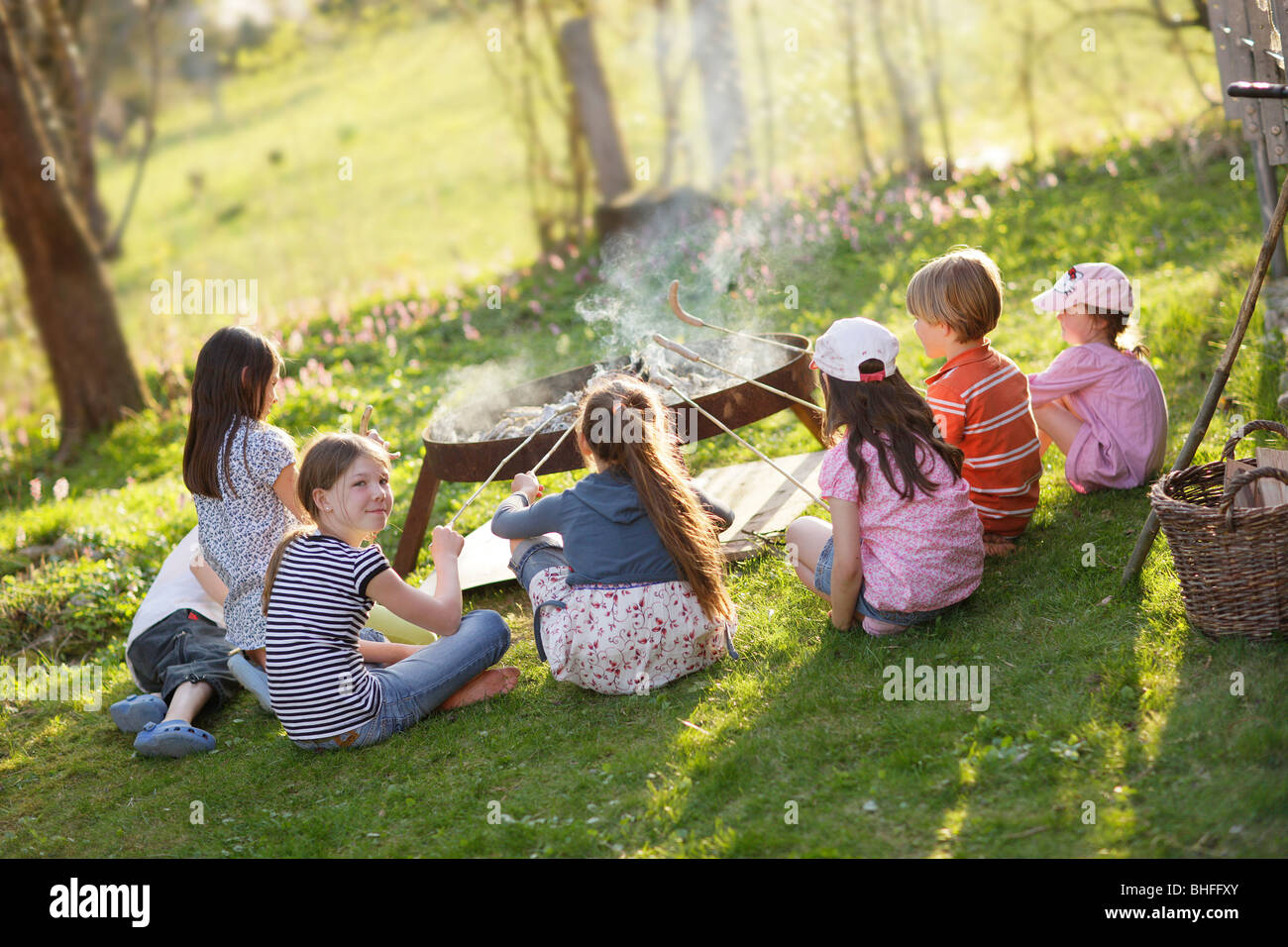 Children barbecueing sausages, Munsing, Bavaria, Germany Stock Photo