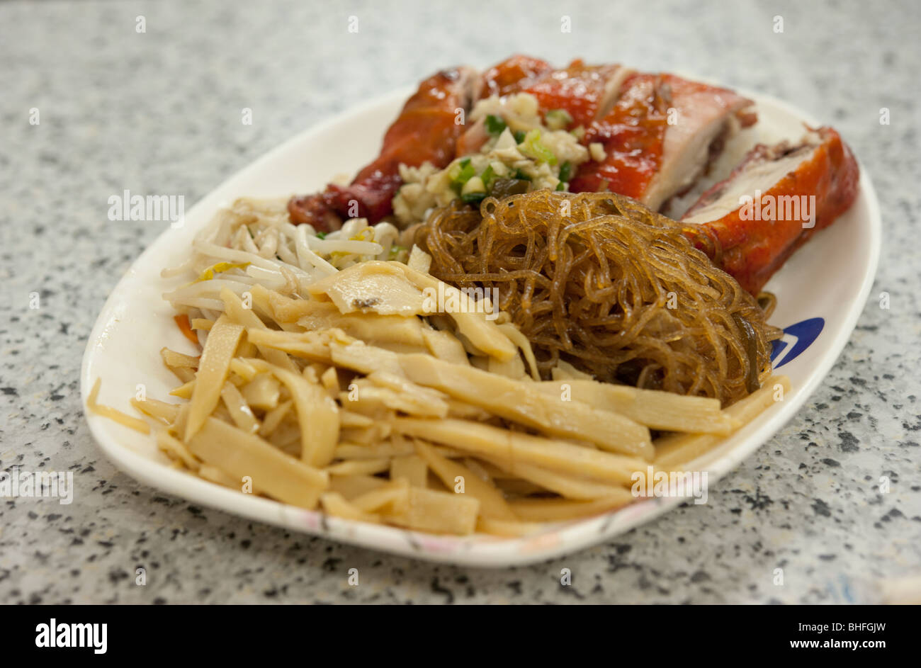 Chinesestyle bamboo shoots, noodles, and a chicken leg served in a
