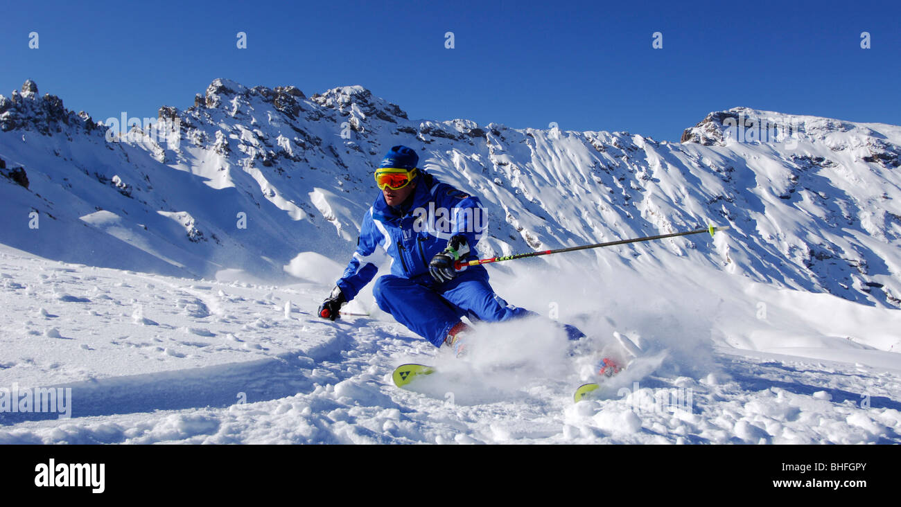 Ski instructor skiing, carving through fresh, powder snow, Mountain landscape in Winter, Seiser Alp, South Tyrol, Italy Stock Photo