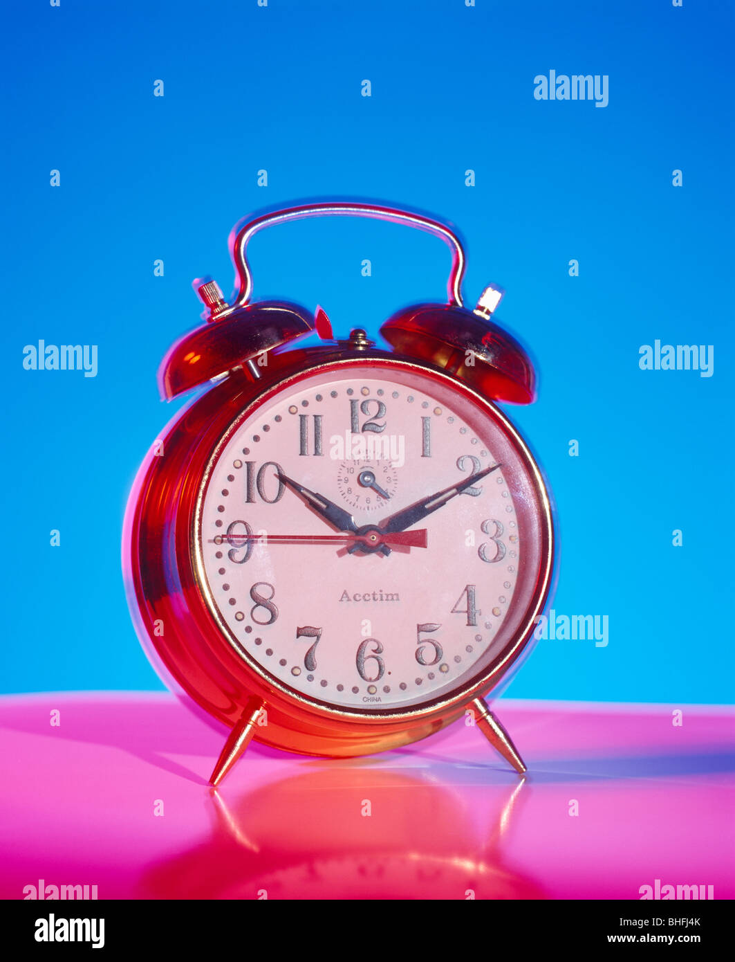 Alarm clock on pink base Stock Photo