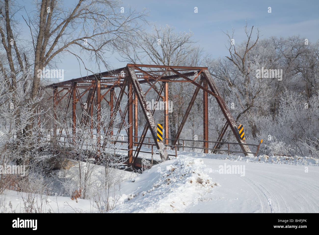 rural road with steel bridge in winter, Winneshiek County, Iowa Stock Photo