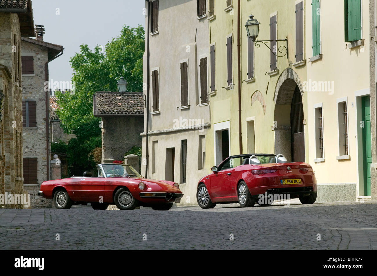 Alfa Spiders (Left )1970's (Right) 2007 example on street in Italian town Stock Photo