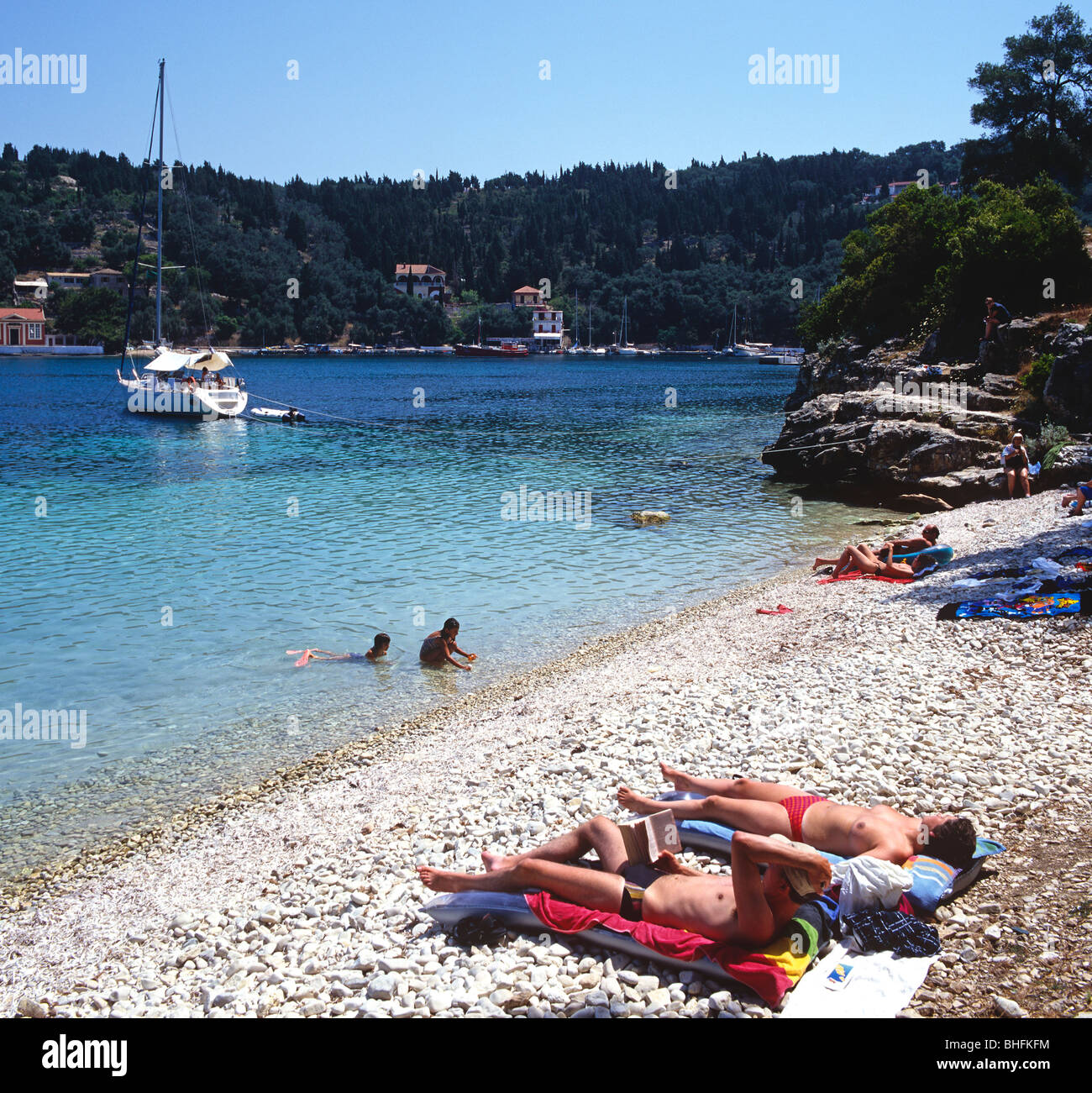 Couple Lying On The Beach In Paxos Greek Islands Greece Hellas Stock Photo