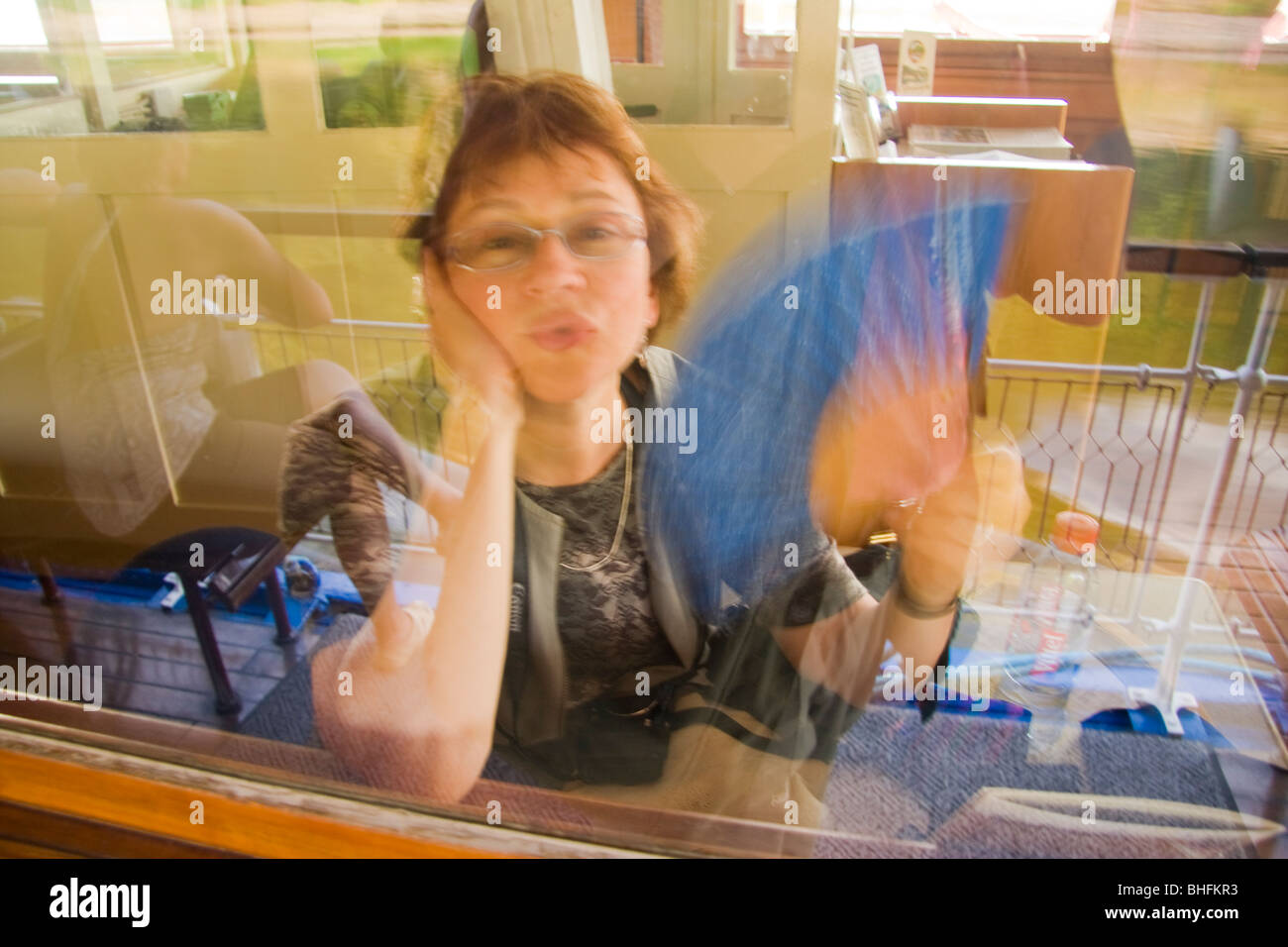flirtatious woman fanning herself on board a river-cruiser on the Elbe river near Dresden Stock Photo