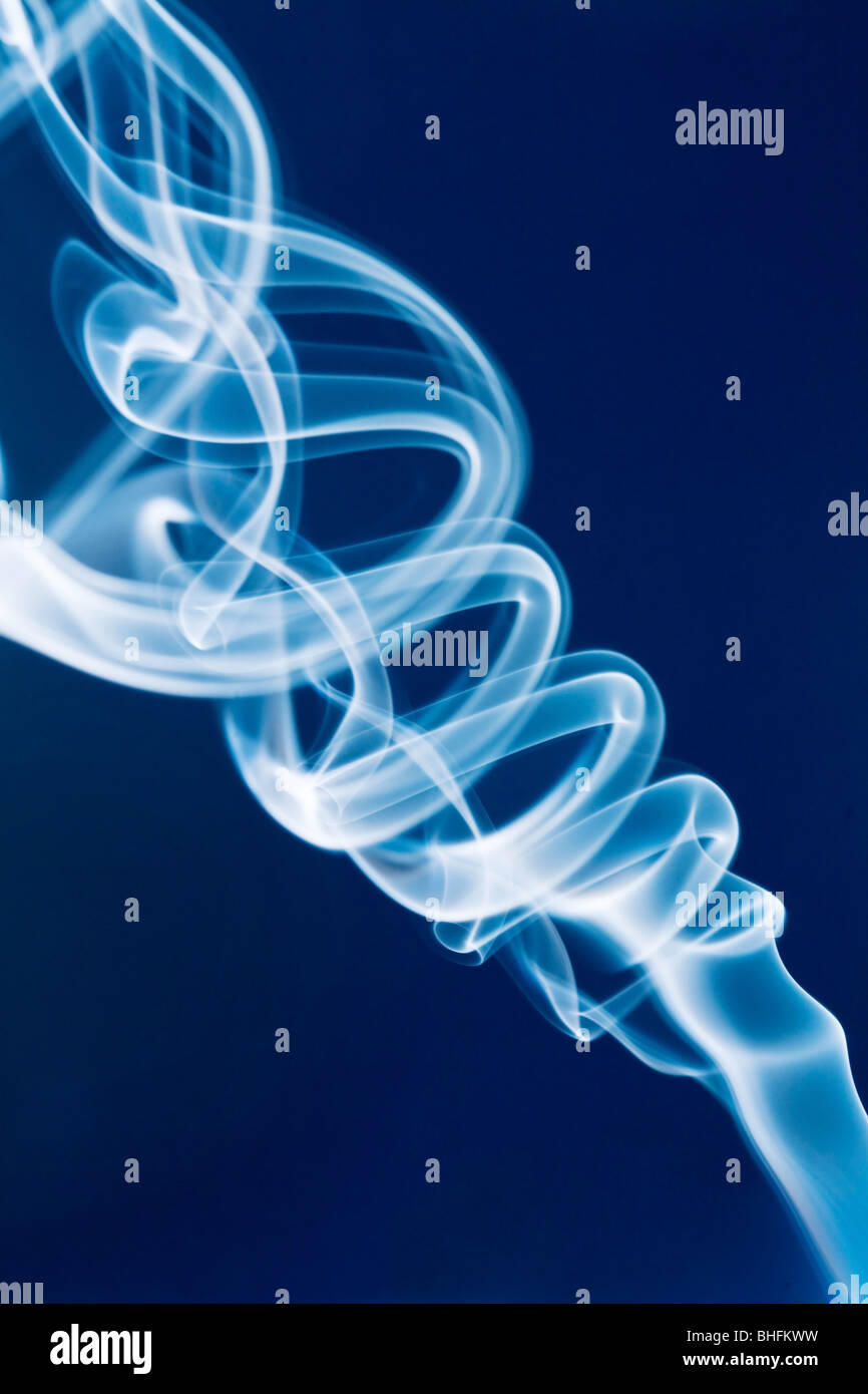Jet of white smoke against a blue background Stock Photo