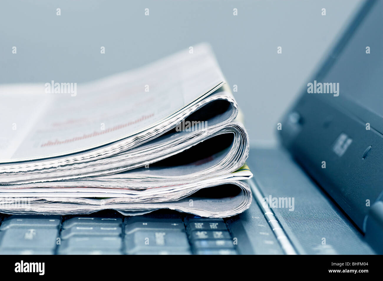 newspapers on the laptop Stock Photo