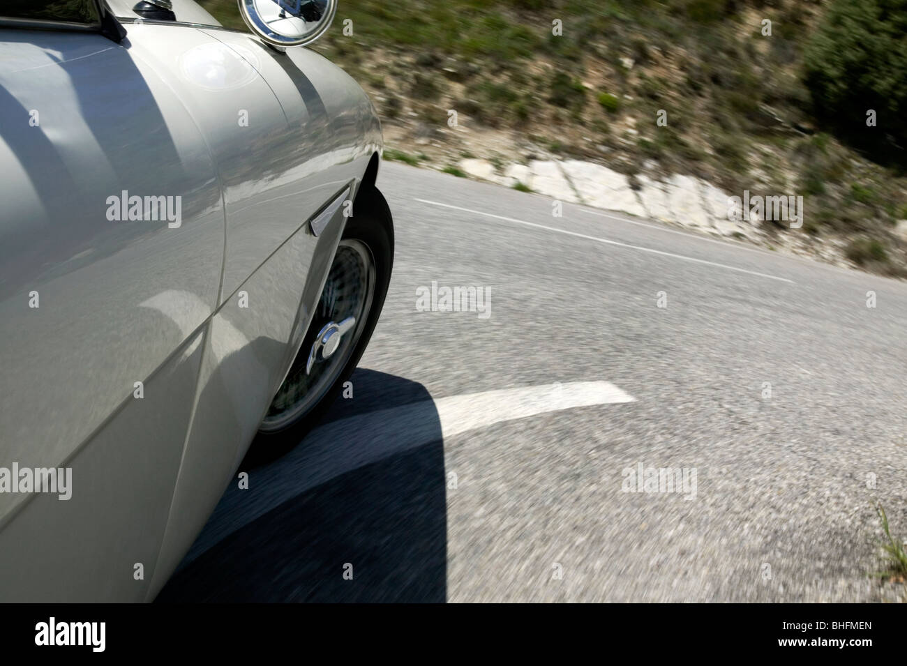 Classic British Sportscar (Austin Healey) cornering on Alpine road. France 2008 Stock Photo