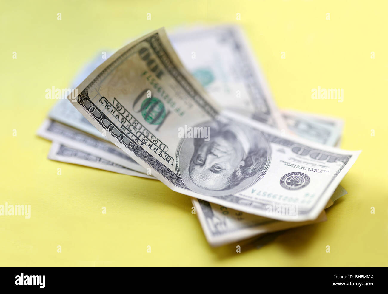 Dollars. Some piece of money over yellow background. Stock Photo