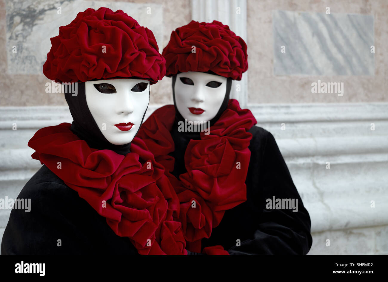 Couple of beautiful female masks in creative red and black costumes at ...