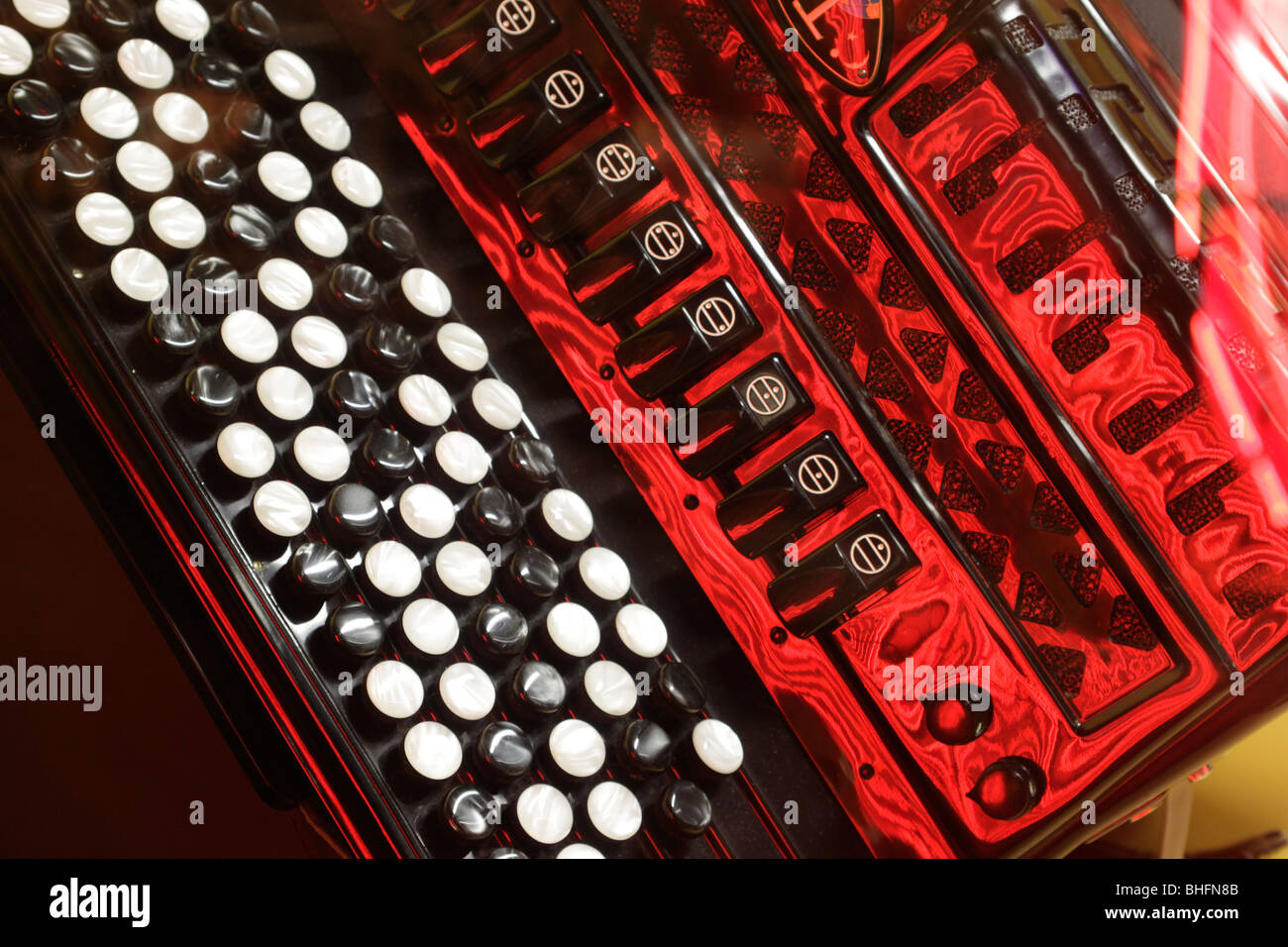 Accordion reflecting red light Stock Photo