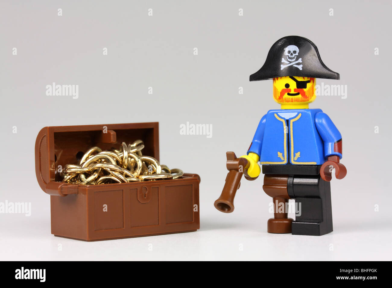 Lego pirate and treasure chest full of gold Stock Photo