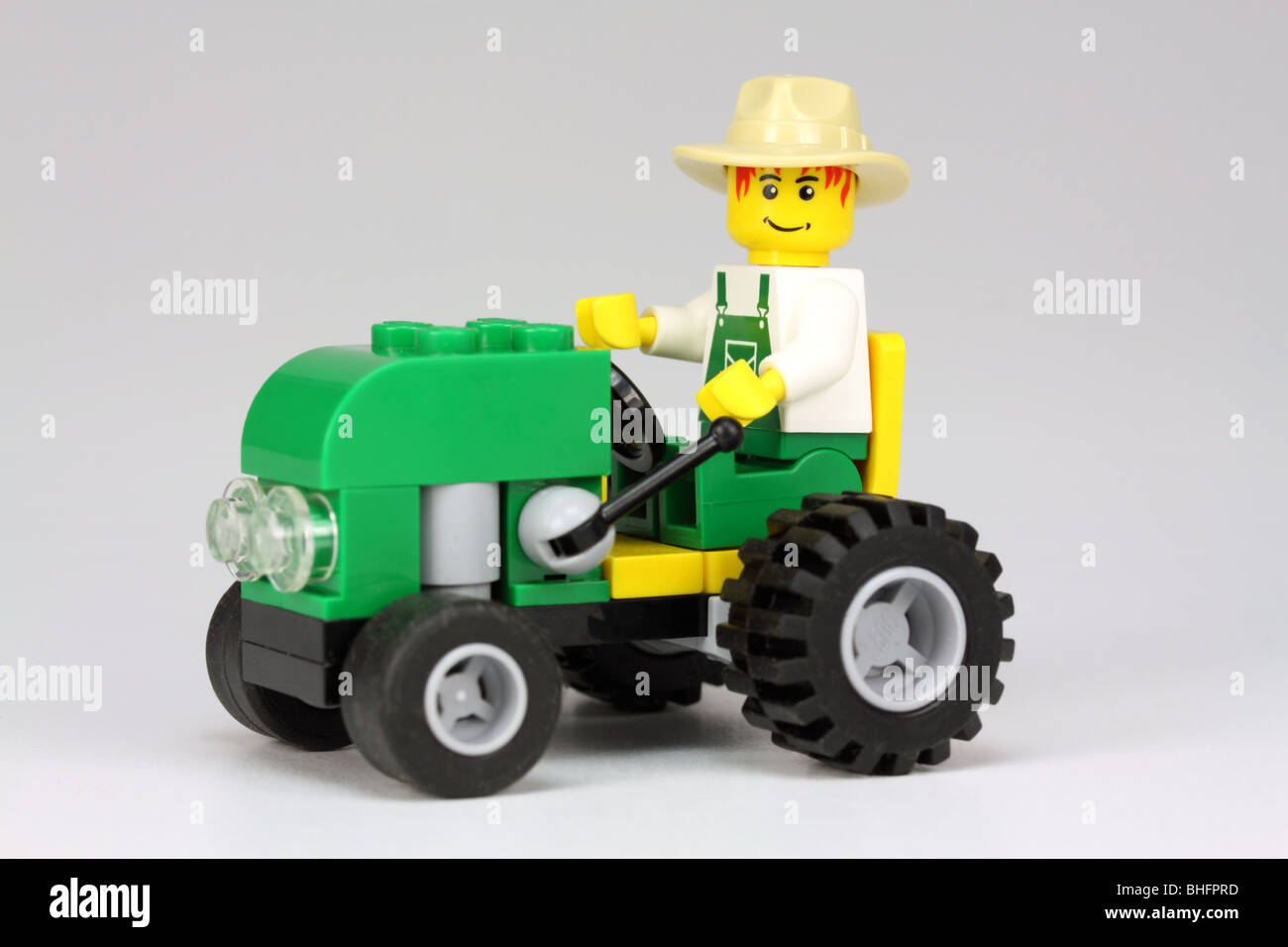 Lego farmer driving tractor Stock Photo