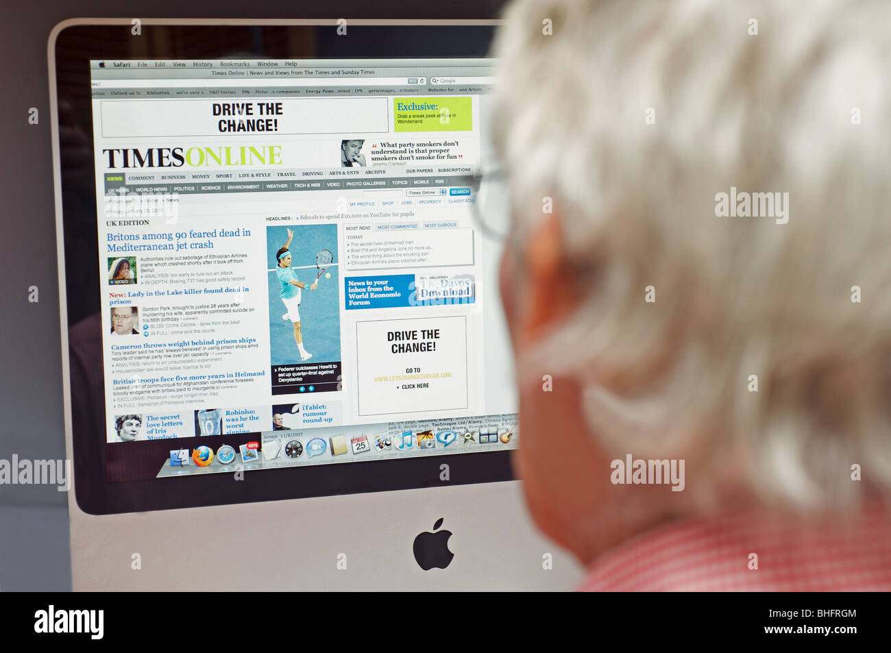 Elderly gentleman reading The Times newspaper online edition on a desktop Apple computer. Stock Photo