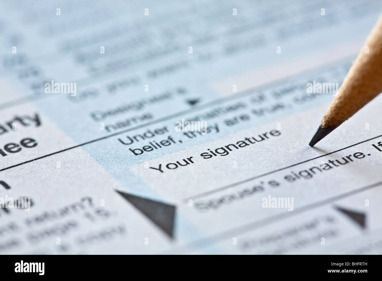 pencil on signature line of tax form Stock Photo Alamy