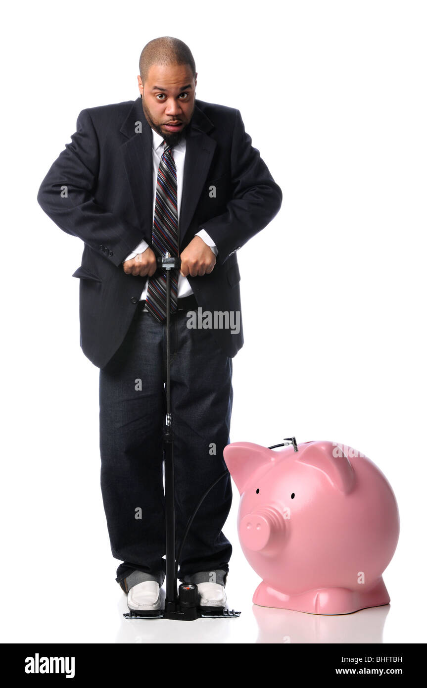 African American businessman inflating piggy bank over white background Stock Photo