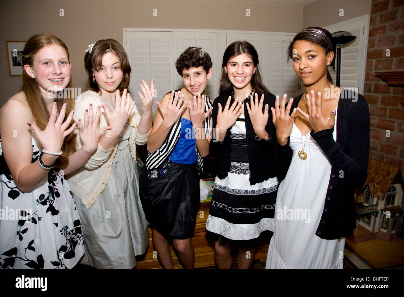 8th grade girls preparing for their Formal Dance at their Middle School. Showing off their new nails. Stock Photo