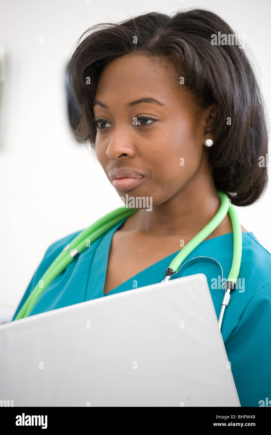 Nurse portrait, smiling black nurse wearing scrubs and a stethoscope