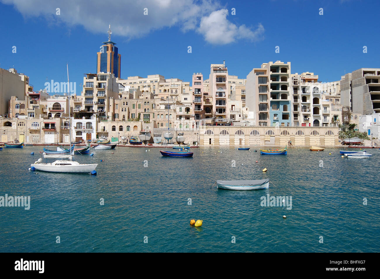 A view of St. Julians bay with buildings being constructed in the background overlooked by the Hilton hotel. Stock Photo