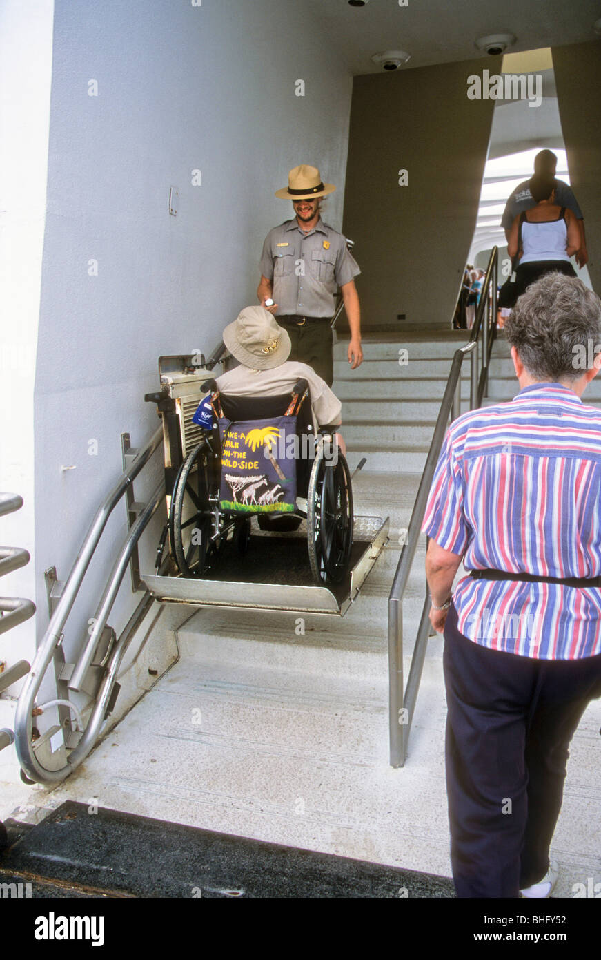 tourist rides wheelchair assist up stairs at national park USA ranger