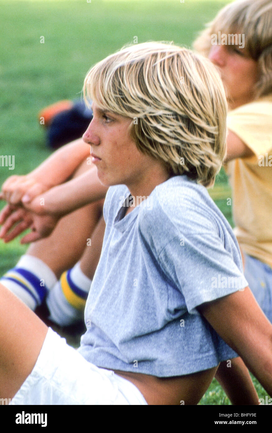 blond boy teen athlete rest team listen coach talk profile face serious  attention Stock Photo - Alamy