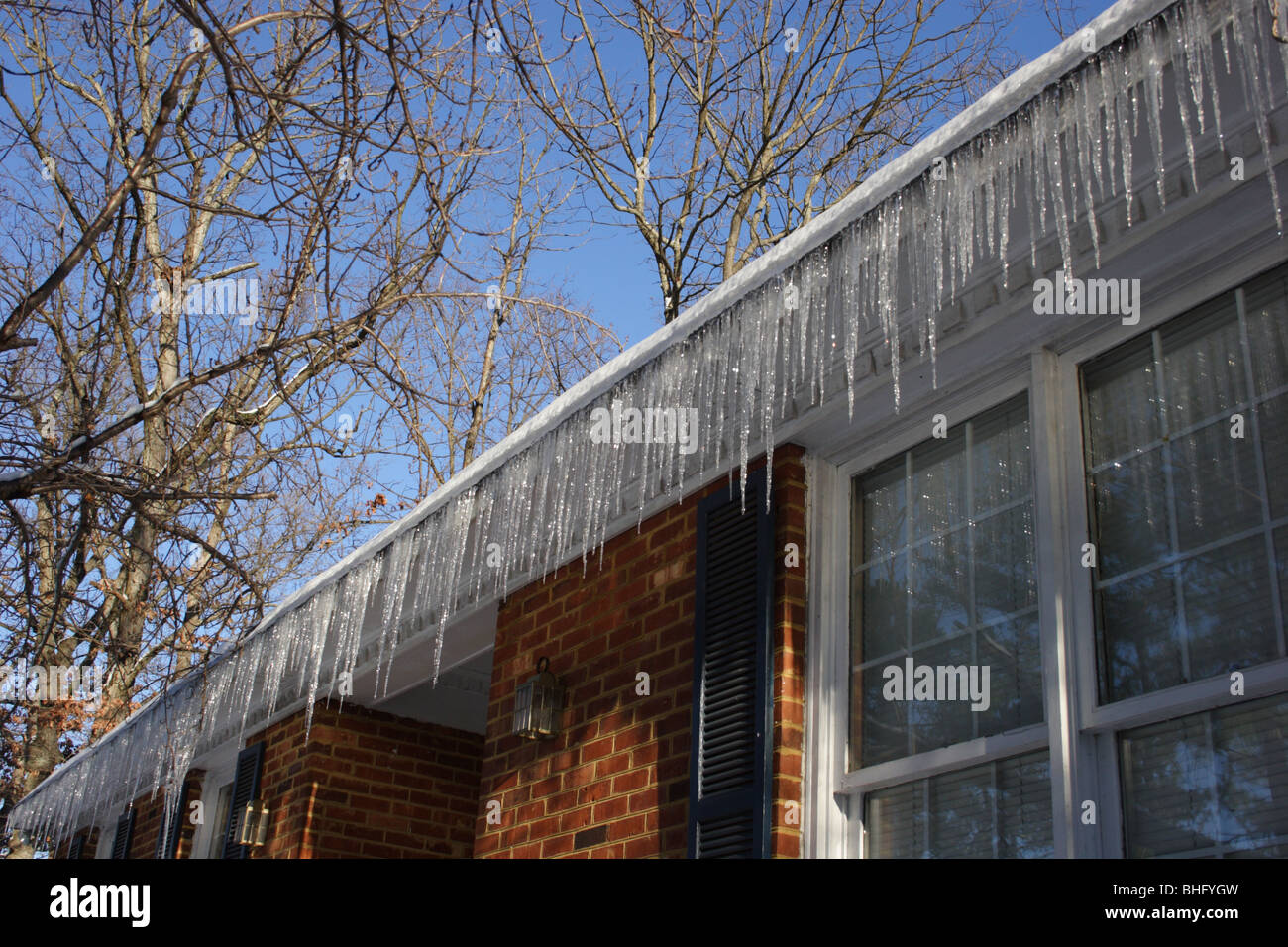 Icicles on house after snowstorm Stock Photo