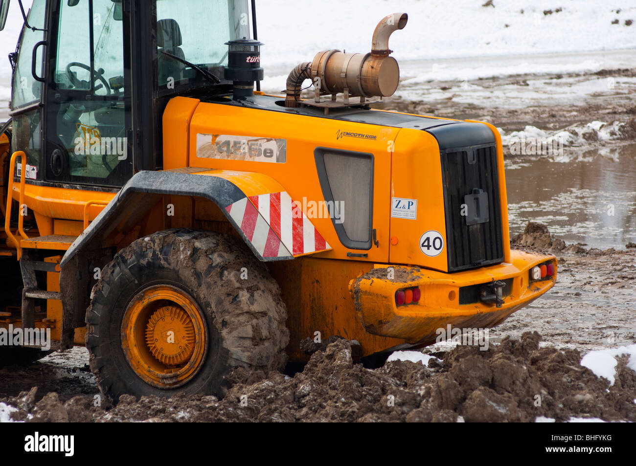 Bulldozer deep in mud and snow Stock Photo