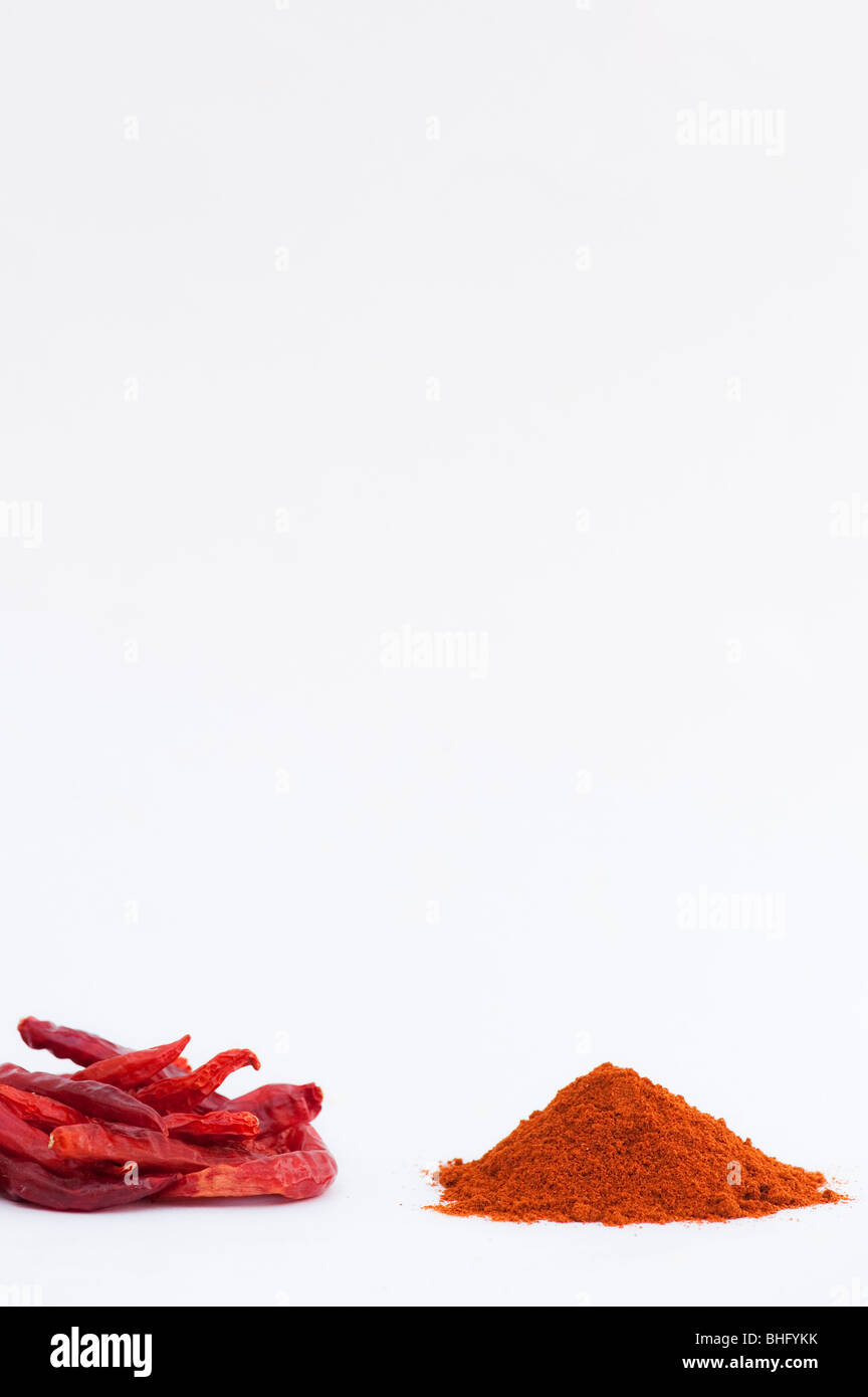 Dried red chili peppers and chilli powder on a white background Stock Photo
