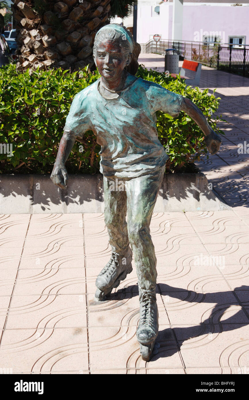 Sculpture in street in Canary islands of young girl rollerblading Stock Photo