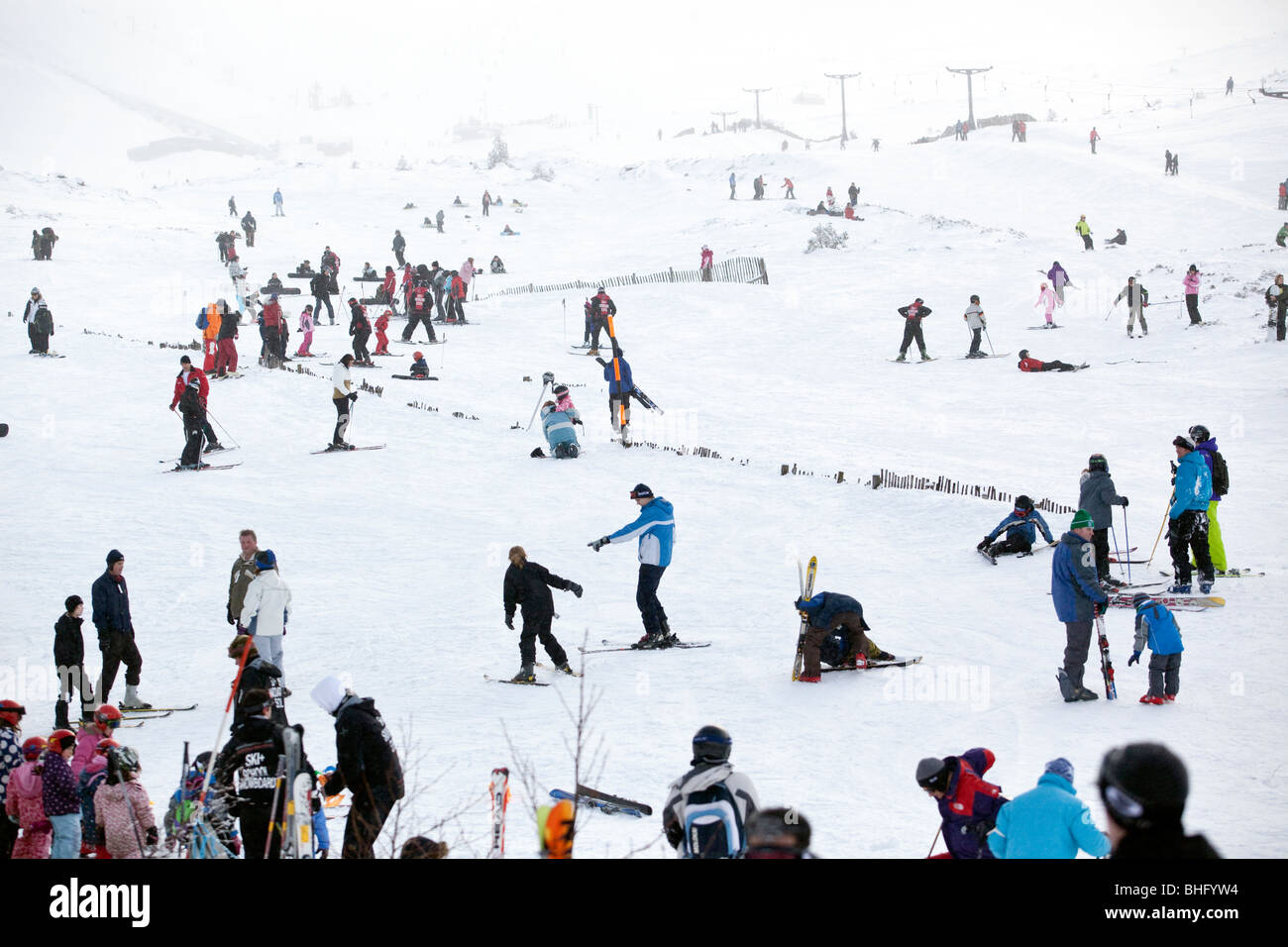 Skiers and snow boarders on the lower slopes of Aviemore in the Cairngorms, Scotland. Stock Photo