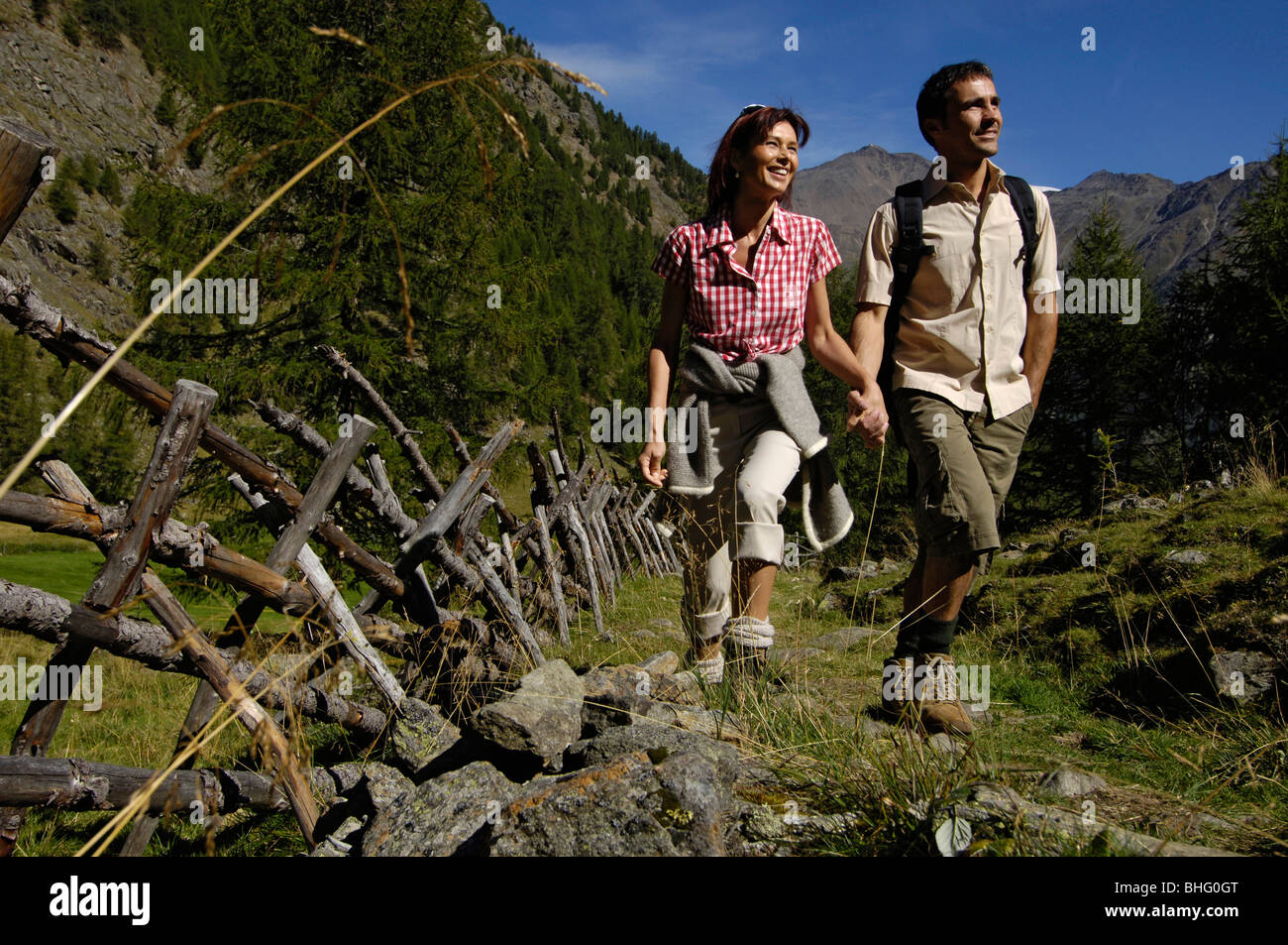 A mid adults couple hiking in the mountains in summer, Val Venosta, Vinschgau, South Tyrol, Italy, Europe Stock Photo