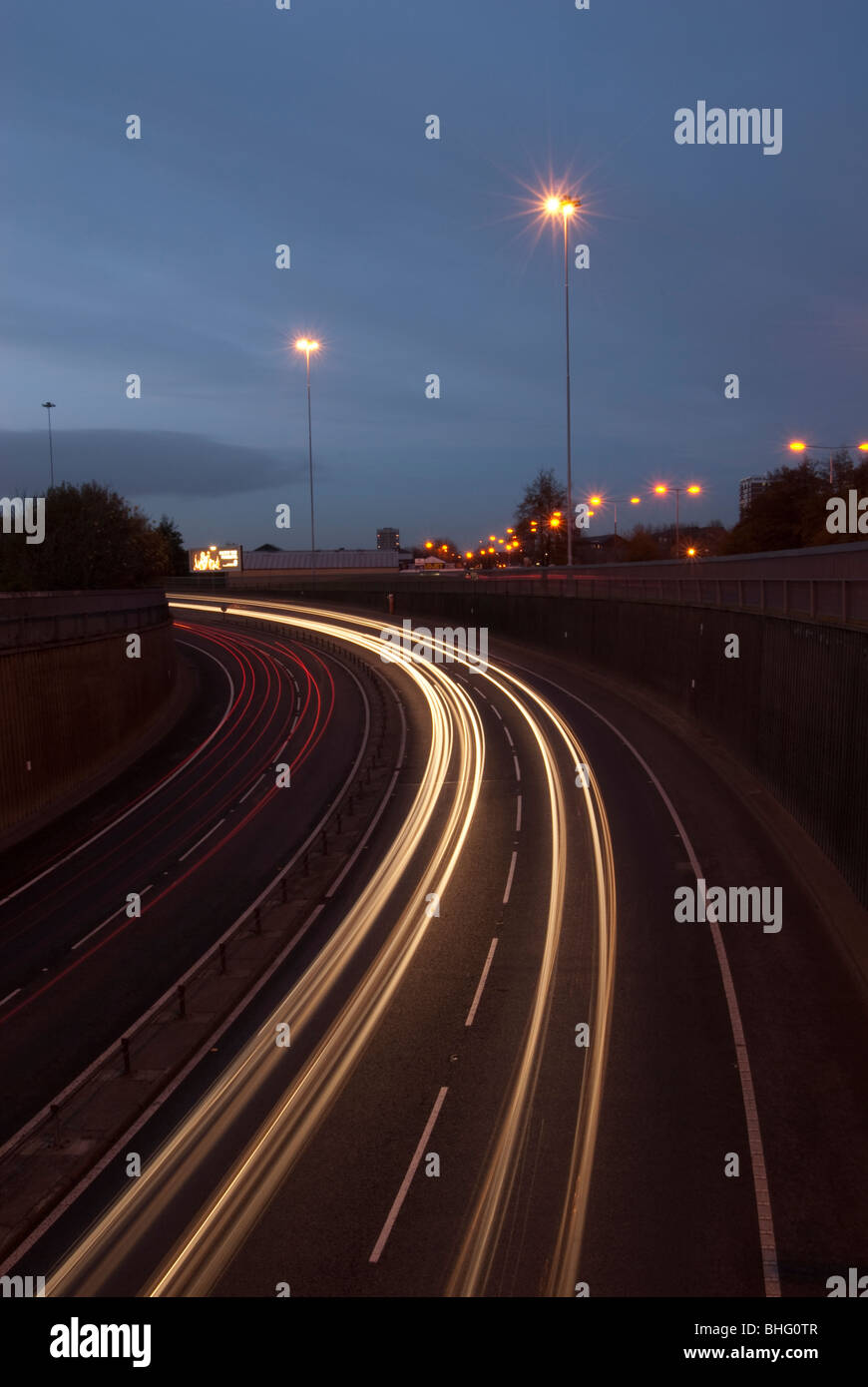 Liverpool to Wallasey Kingsway Tunnel UK approach road at night with car headlight trails Stock Photo
