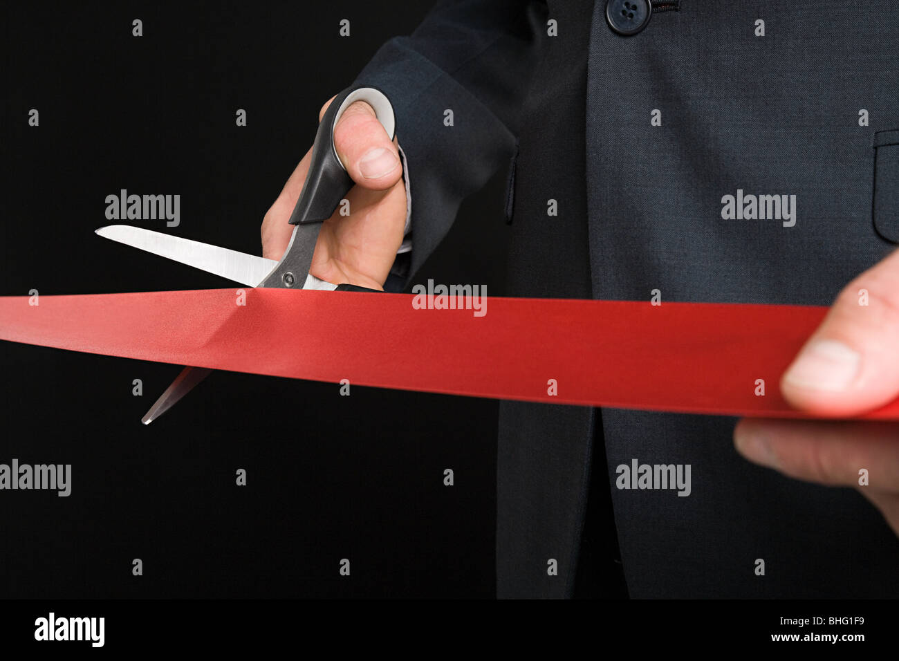 Businessman cutting a red ribbon Stock Photo