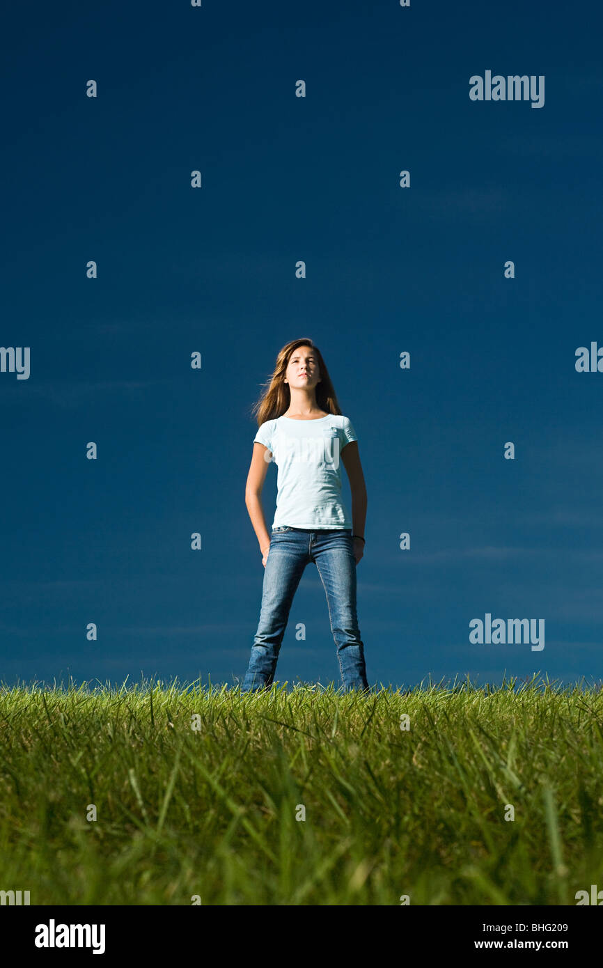 Girl standing in a field Stock Photo - Alamy