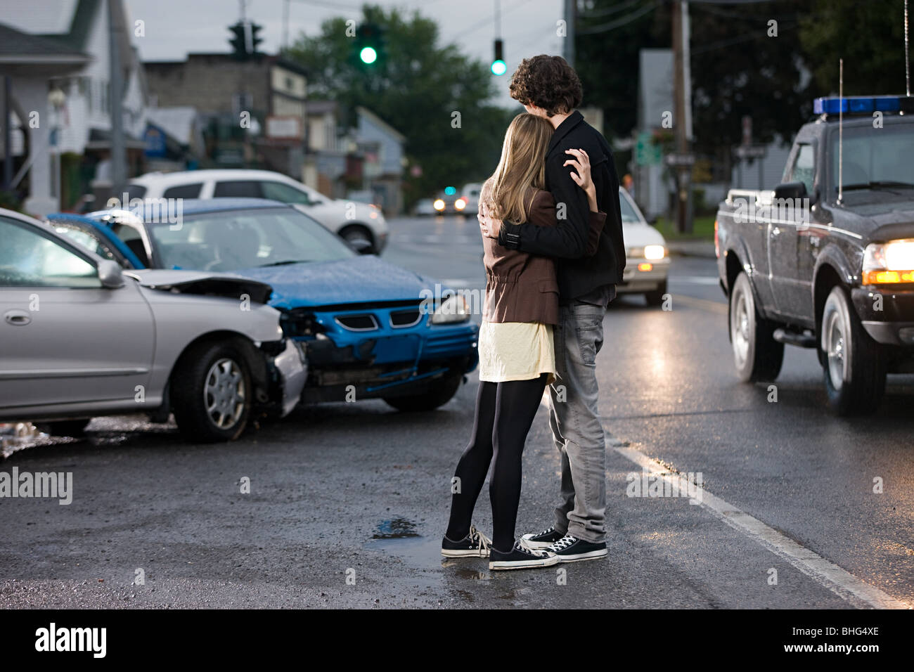 Young couple looking at crashed cars Stock Photo