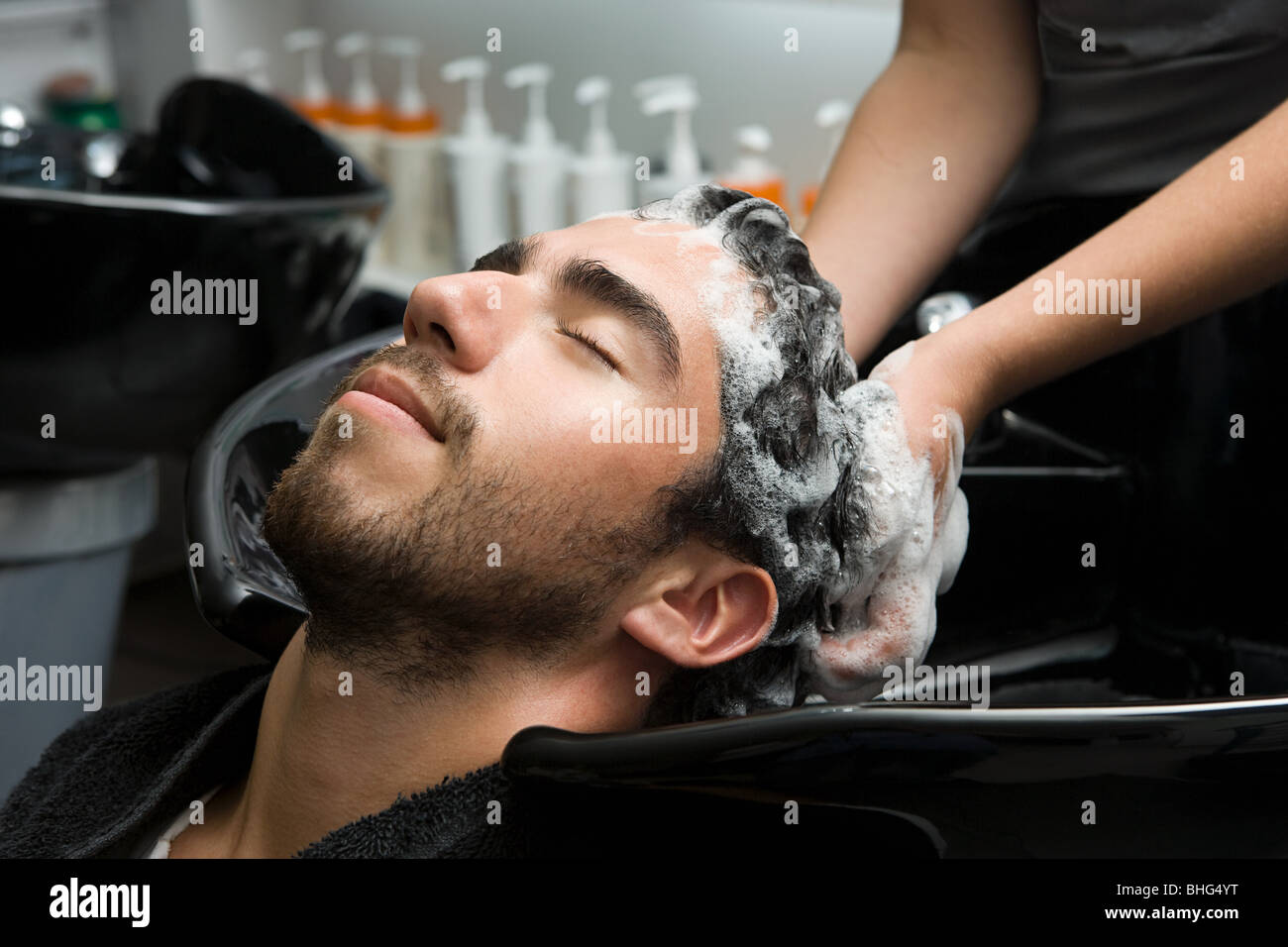 Man having his hair shampooed Stock Photo