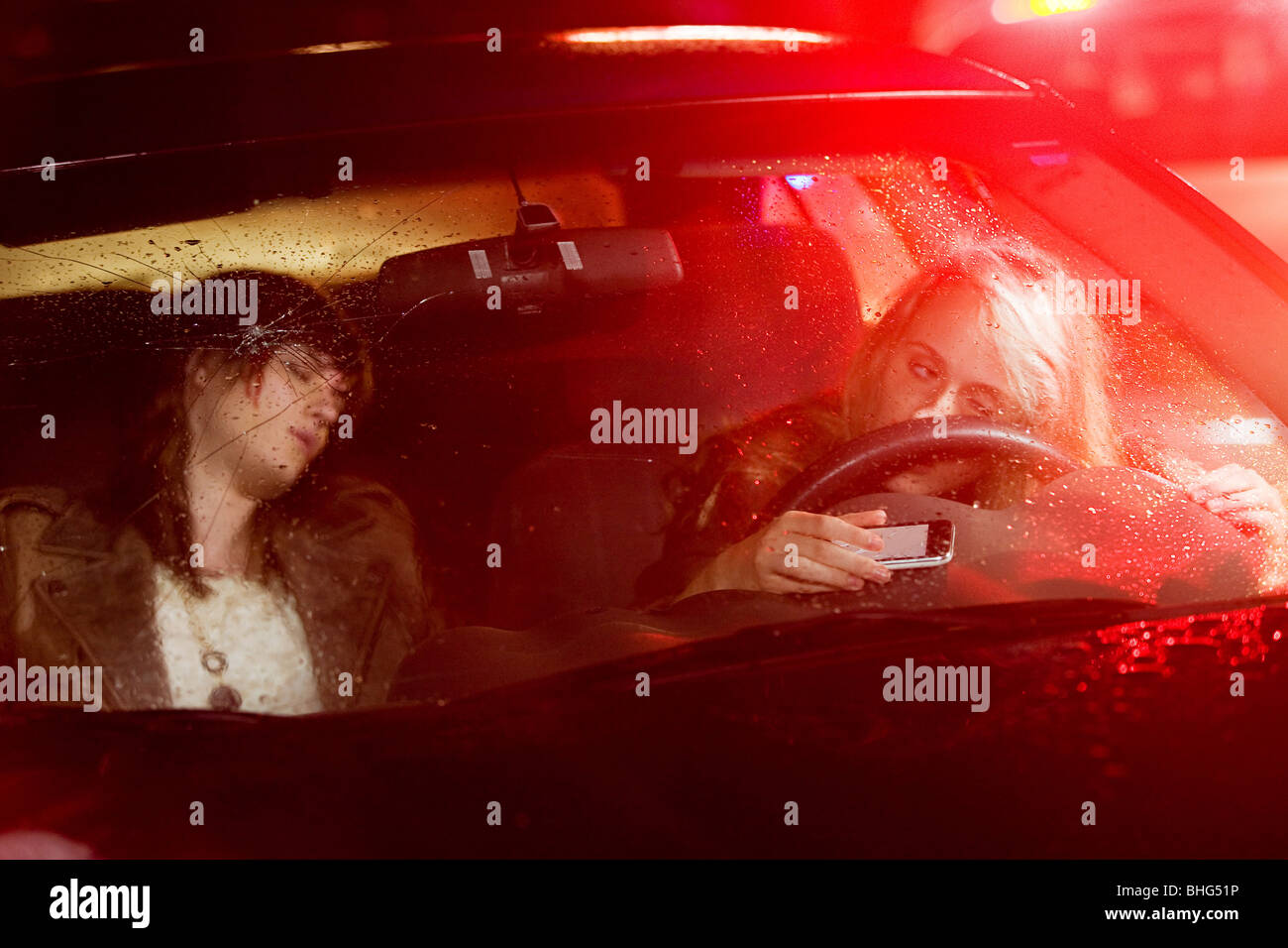 Two young women in a car accident Stock Photo