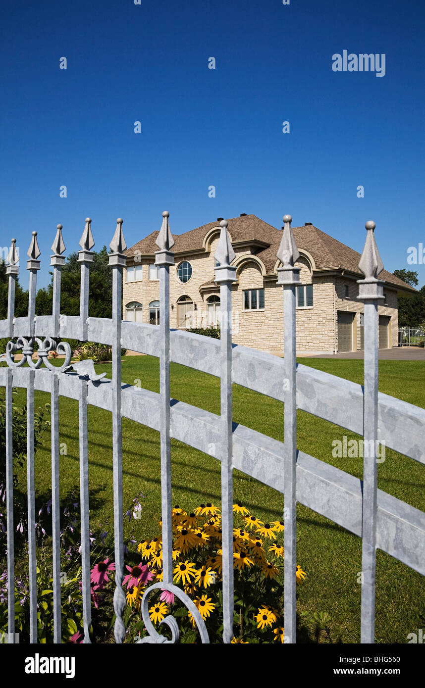 Large house behind gate Stock Photo