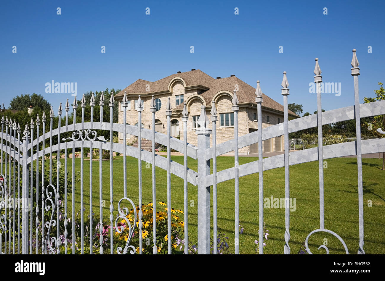 Large house behind gate Stock Photo