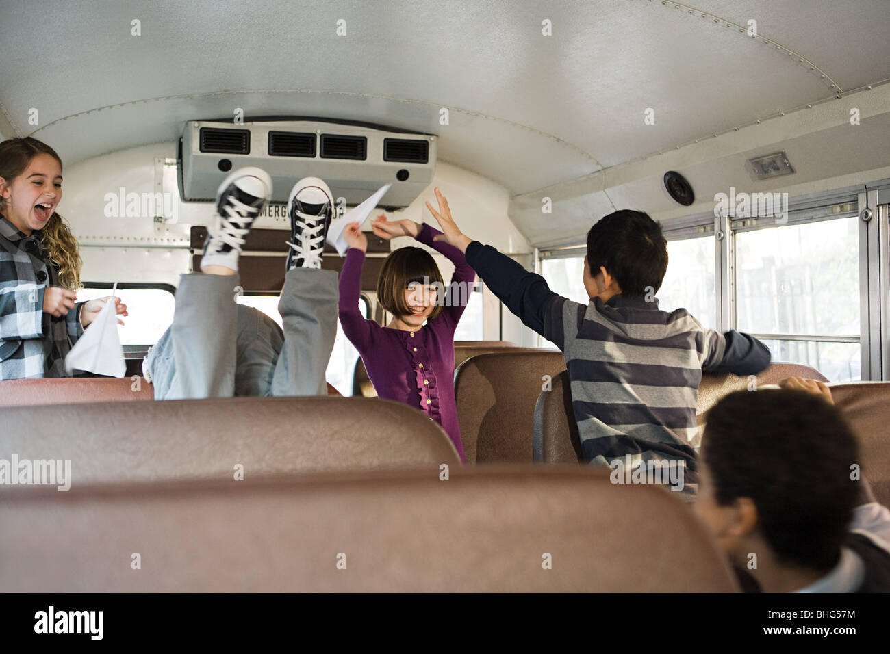 Children having fun on school bus Stock Photo