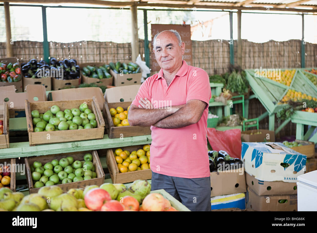 Market trader at fruit and vegetable stall Stock Photo