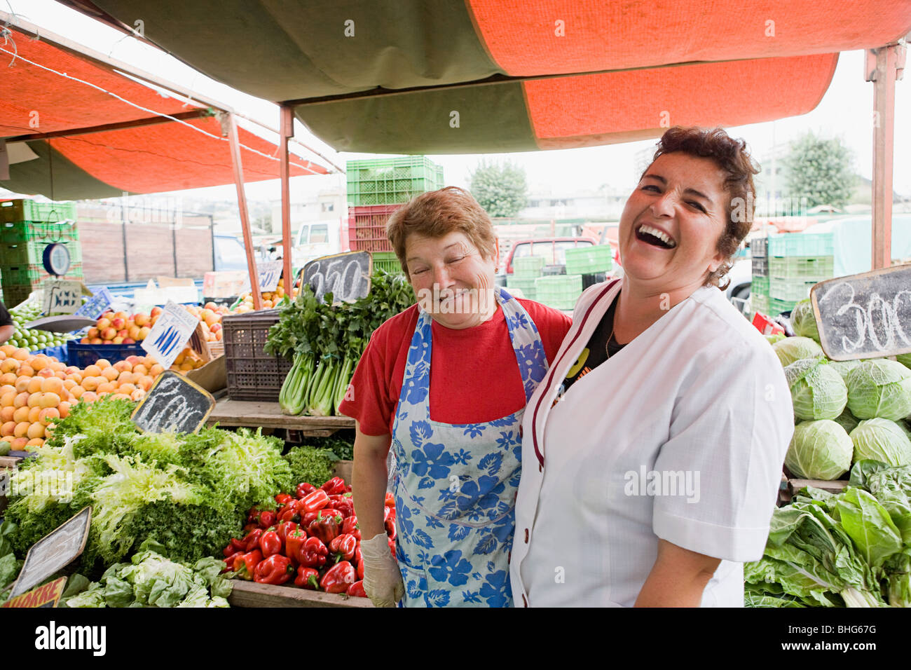 Two female traders on vegetable stall Stock Photo