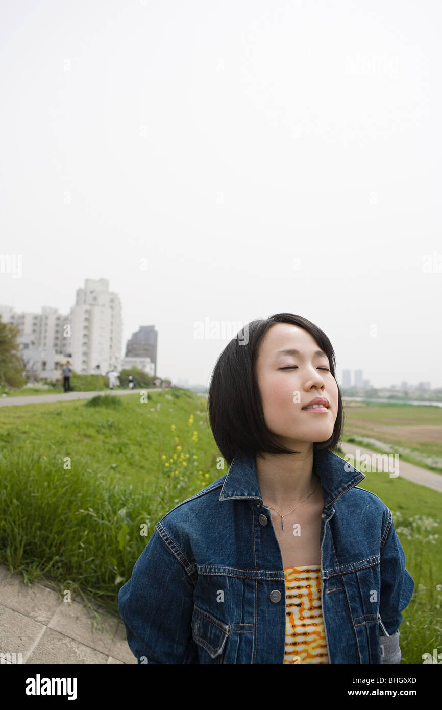 Young woman outdoors with eyes closed Stock Photo - Alamy