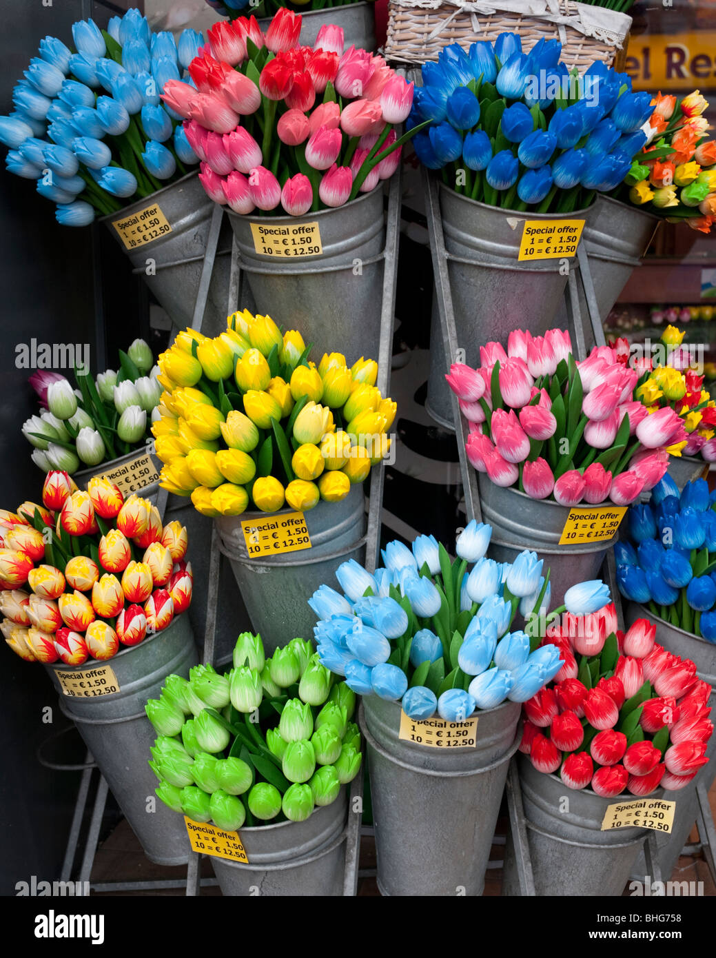 Detail of many colourful plastic tulip flowers in a tourist shop in Amsterdam Netherlands Stock Photo